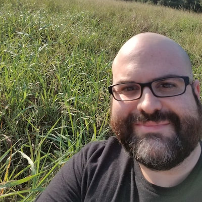 Selfie of Michael McKain, standing in front of field of Johnsongrass
